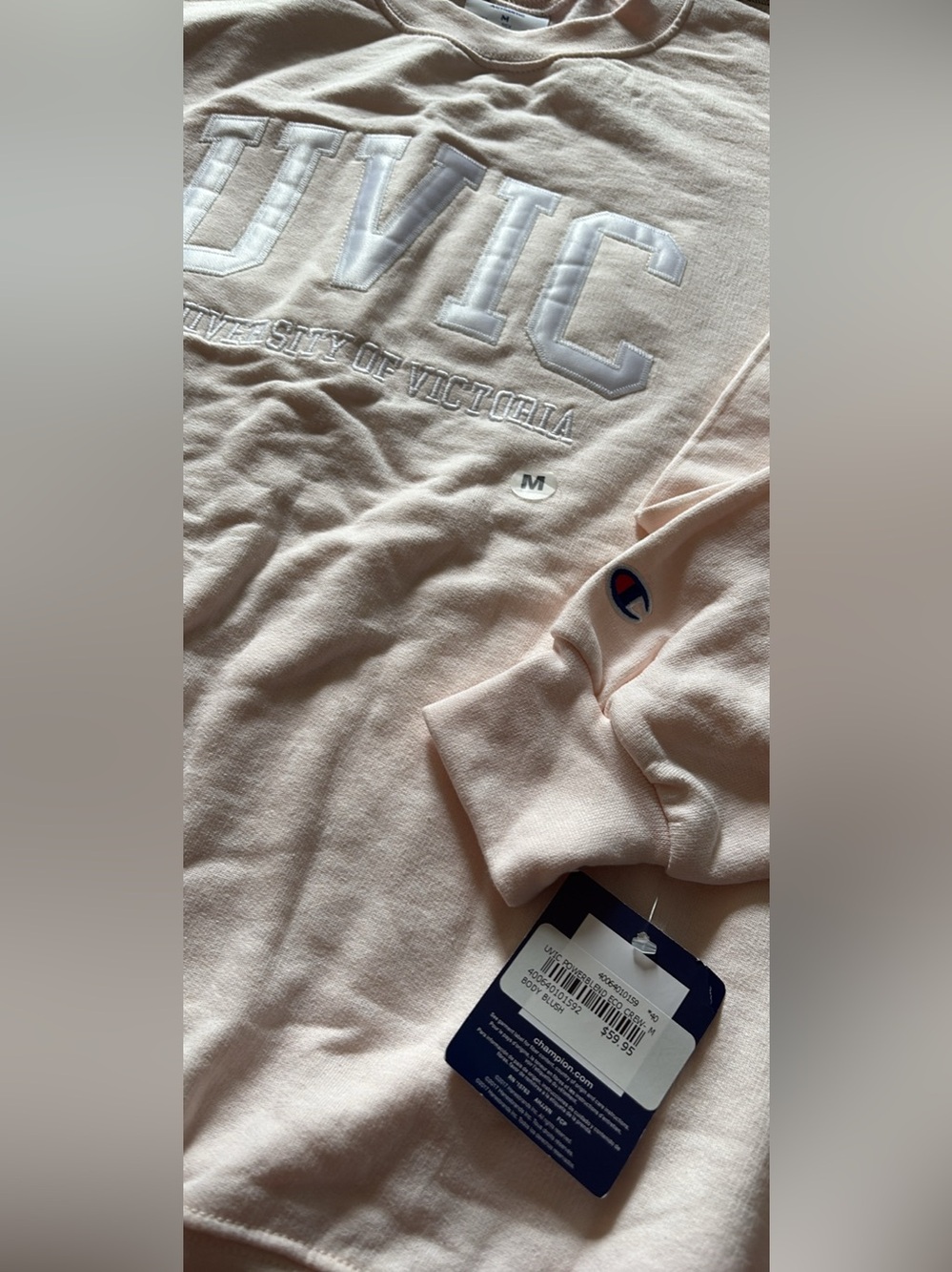 Champion women’s light pink Crewneck Sweatshirt with Embroidered University Text